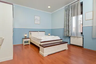 a bedroom with a bed and a blue wall at Life in Colors - Elegant 2BD Premium Stay by Flat Mаnager in Sofia