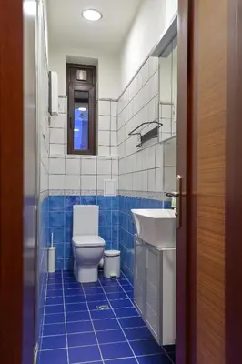 a blue tiled bathroom with a toilet and a sink at Life in Colors - Elegant 2BD Premium Stay by Flat Mаnager in Sofia