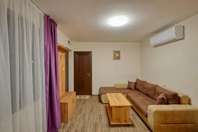 a living room with a couch and a coffee table at Комплекс Колонада in Hisarya