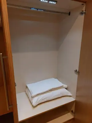 a closet with white towels sitting on a shelf at Residence E205 Euphoria Borovets in Borovets