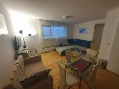 a living room with a couch and a table at Mila Apartment in Bansko