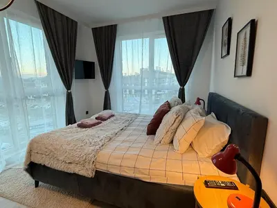 a bedroom with a bed with a view of a city at The Tower - Lovely apartment @ Bansko Royal Towers in Bansko