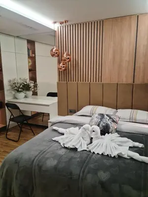 a bedroom with two dolls laying on a bed at Апартамент Мегилукс 2 in Blagoevgrad