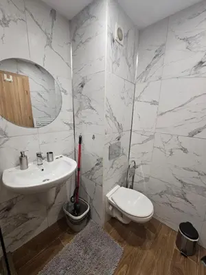 a white bathroom with a sink and a toilet at Rustic Mountain Apartment - A55 in Borovets