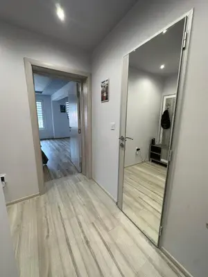 an empty room with a mirror and a hallway at Central Vista Apartment by MIT in Sofia