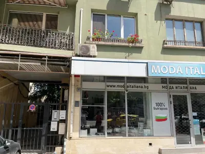 a building with a moda rental sign on it at Central Vista Apartment by MIT in Sofia
