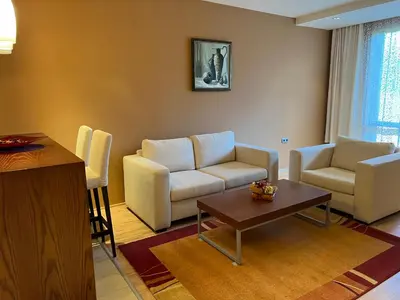 a living room with a couch and a table at St Trifon Guests Apartments in Pamporovo