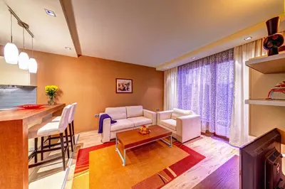 a living room with a couch and a table at St Trifon Guests Apartments in Pamporovo