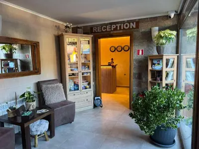 a room with a waiting room with a couch and a table at St Trifon Guests Apartments in Pamporovo