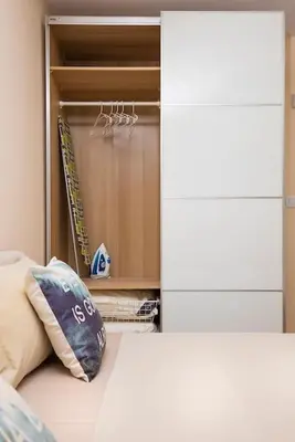 a bedroom with a bed with a pillow and a closet at 2BR apartment ,10 minutes walk to TOP Center in Plovdiv