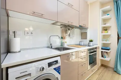 a white kitchen with a sink and a dishwasher at 2BR apartment ,10 minutes walk to TOP Center in Plovdiv