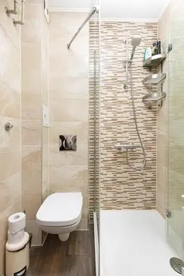 a bathroom with a shower with a toilet and a sink at 2BR apartment ,10 minutes walk to TOP Center in Plovdiv
