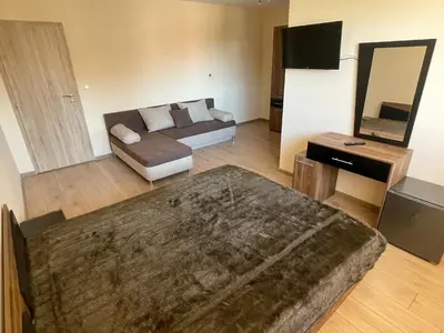 a large living room with a couch and a television at Villa Stoyanovata Kashta in Samokov