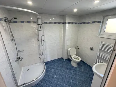 a bathroom with a toilet and a shower and a sink at Villa Stoyanovata Kashta in Samokov