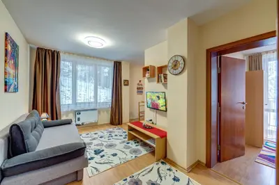 a living room with a couch and a table at Cozy and Cute 1BD Apartment in The Castle Complex by Flat Mаnager in Pamporovo