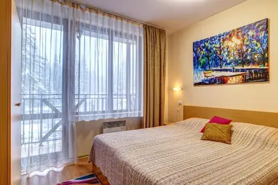 a bedroom with a bed and a large window at Cozy and Cute 1BD Apartment in The Castle Complex by Flat Mаnager in Pamporovo