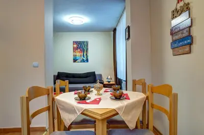 a dining room with a table and chairs at Cozy and Cute 1BD Apartment in The Castle Complex by Flat Mаnager in Pamporovo