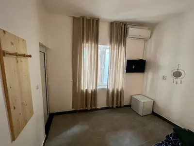an empty room with a window with curtains at The rainbow 2 in Sofia