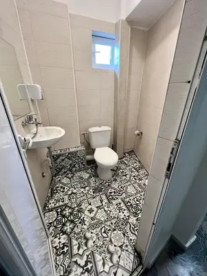 a bathroom with a toilet and a sink at The rainbow 2 in Sofia