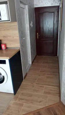 a hallway leading to a kitchen with a door at Студио Еми in Chepelare