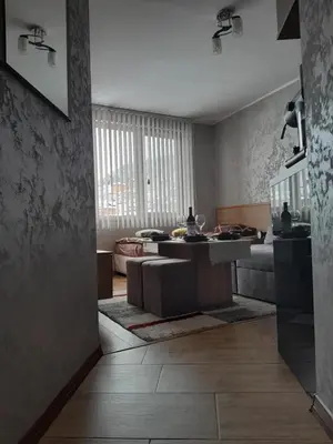 a living room with a couch and a table at Студио Еми in Chepelare