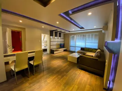 a large living room with a couch and a table at Modern 1BR Apartment with Garden View & Free street parking in Plovdiv
