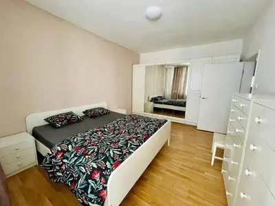 a bedroom with a bed and a dresser at 2-BDR Flat Near the Mall, Spacious & Cozy by Flat Mаnager in Sofia