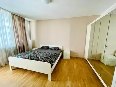a bedroom with a bed and a wooden floor at 2-BDR Flat Near the Mall, Spacious & Cozy by Flat Mаnager in Sofia