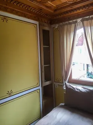 a bedroom with a bed and a window at Стаи за гости Бащино огнище in Koprivshtitsa