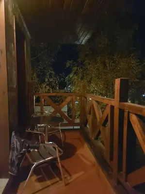 a balcony with a chair and a speaker on a fence at Apartment in Bansko in Bansko