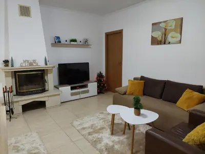 a living room with a couch and a tv at Apartments WinterFell ,Grand Monastery ,Pamporovo in Pamporovo