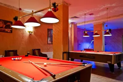 a billiard room with a pool table and lights at Apartments WinterFell ,Grand Monastery ,Pamporovo in Pamporovo