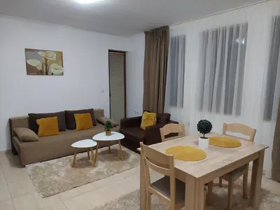 a living room with a couch and a table and chairs at Apartments WinterFell ,Grand Monastery ,Pamporovo in Pamporovo