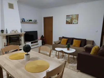 a living room with a table and a couch at Apartments WinterFell ,Grand Monastery ,Pamporovo in Pamporovo