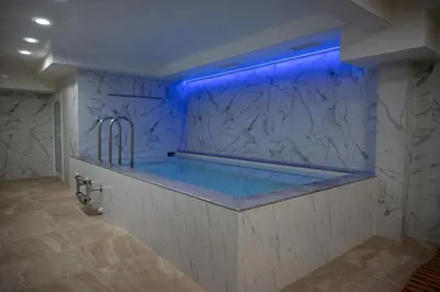 a bathroom with a tub with a blue lighting at Lime House, Kyustendil in Kyustendil
