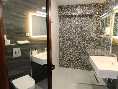 a bathroom with a toilet and a sink and a shower at Lime House, Kyustendil in Kyustendil