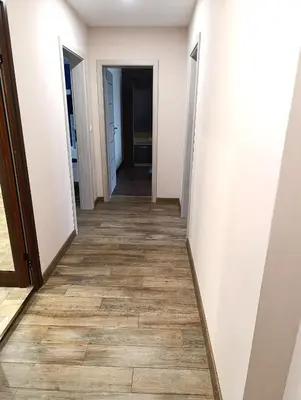 a hallway with white walls and wooden floors at Lime House, Kyustendil in Kyustendil