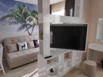 a living room with a large flat screen tv at Lime House, Kyustendil in Kyustendil