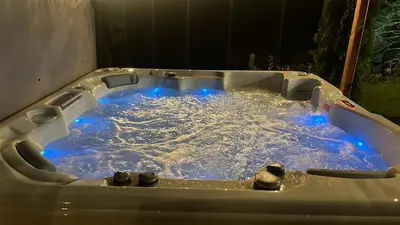 a jacuzzi tub with blue lights in it at Chalet Iskar Borovets by BookVillaBG in Borovets
