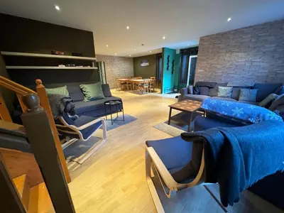 a living room with a blue couch and chairs at Chalet Iskar Borovets by BookVillaBG in Borovets