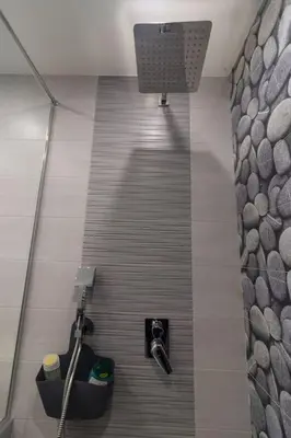a walkway in a bathroom with a shower and a toilet at Unique Central 1 Bedroom Flat in Sofia