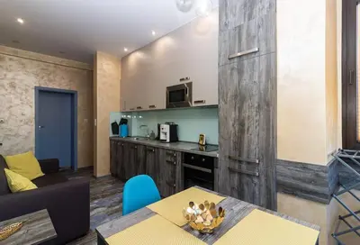 a living room with a table and a kitchen at Unique Central 1 Bedroom Flat in Sofia