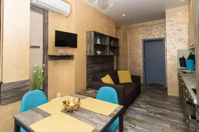 a living room with a couch and a table at Unique Central 1 Bedroom Flat in Sofia