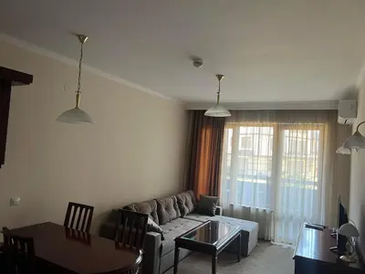 a living room with a couch and a table at Elinor Apartment - Downtown in Bansko