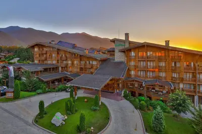 an aerial view of a hotel with mountains in the background at Pirin Golf Private Apartments & Studios in Razlog