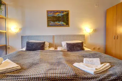 a bedroom with a large bed with towels on it at Complex Silver Hills in Smolyan