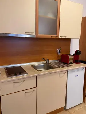 a kitchen with a sink and a counter top at HQ Apartment Flora Violet in Borovets