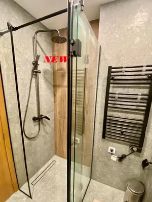 a shower with a glass door in a bathroom at Antonovi Apartments 1 in hotel Laplandia in Pamporovo