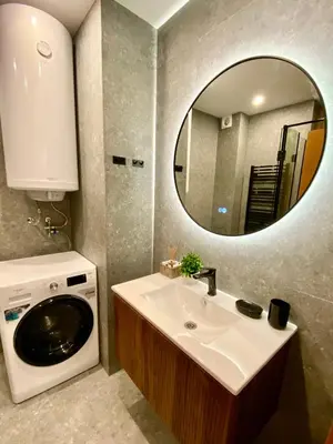 a bathroom with a sink and a washing machine at Antonovi Apartments 1 in hotel Laplandia in Pamporovo