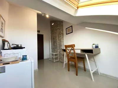 a dining room with a table and a chair at LK17 - Loft in the Center in Sofia